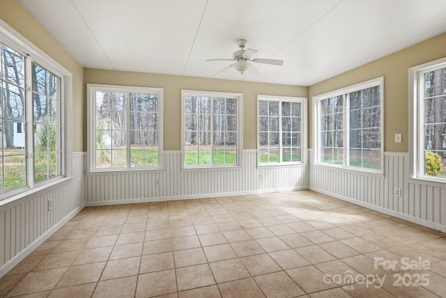 unfurnished sunroom featuring plenty of natural light and ceiling fan