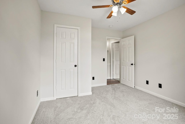 unfurnished bedroom with baseboards, carpet floors, and a ceiling fan