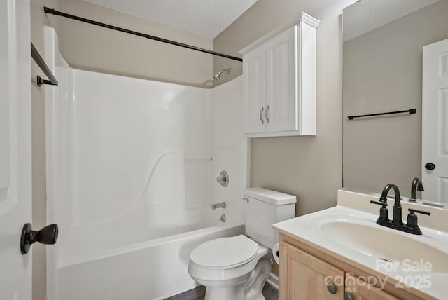 full bathroom featuring vanity, toilet, washtub / shower combination, and a textured ceiling