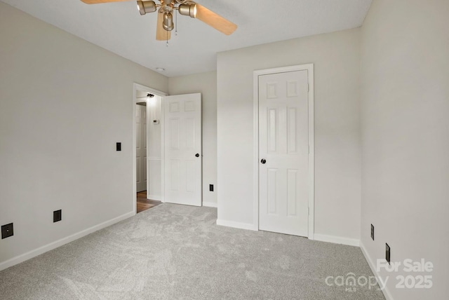 unfurnished bedroom with carpet, baseboards, and ceiling fan