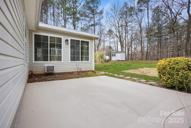 view of patio / terrace with an outdoor structure and a shed