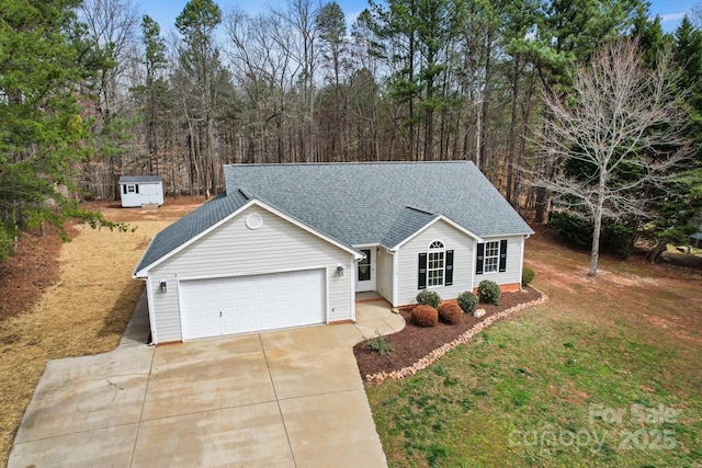 ranch-style house featuring an attached garage, a shingled roof, a front yard, and concrete driveway