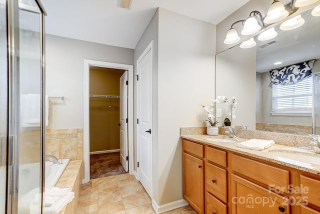 bathroom featuring double vanity, a sink, a garden tub, and visible vents