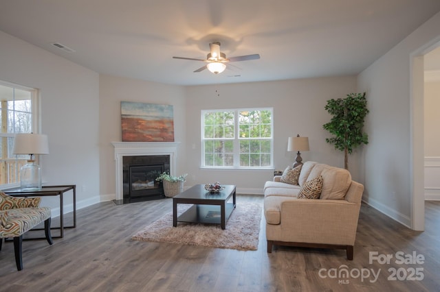 living room with plenty of natural light, wood finished floors, and visible vents