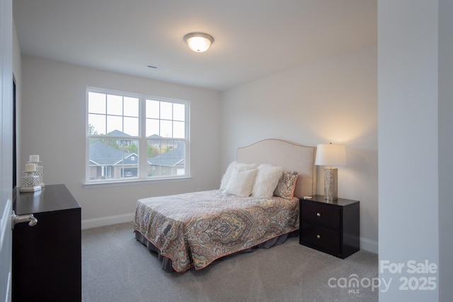 bedroom with visible vents, carpet flooring, and baseboards