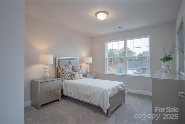 bedroom with light carpet, visible vents, and baseboards