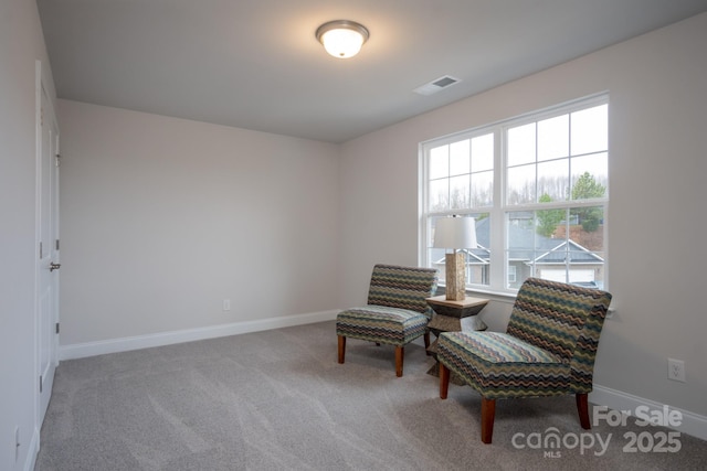 sitting room with carpet, visible vents, and baseboards