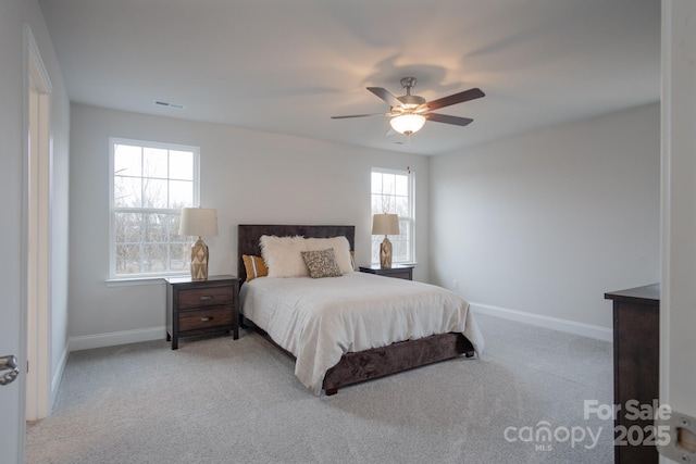 bedroom featuring visible vents, baseboards, carpet, and ceiling fan