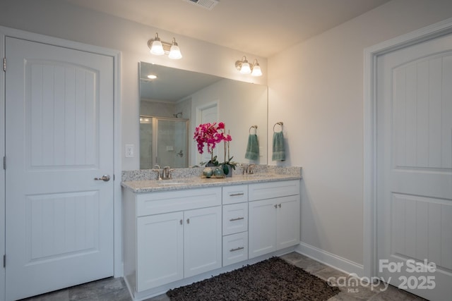 bathroom featuring a sink, visible vents, double vanity, and a shower stall