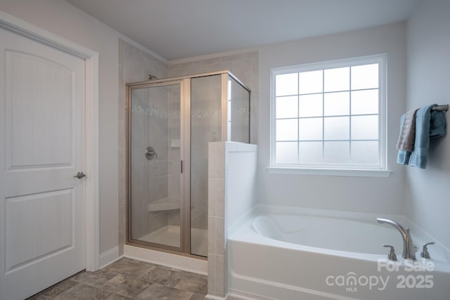 bathroom with a bath and a shower stall