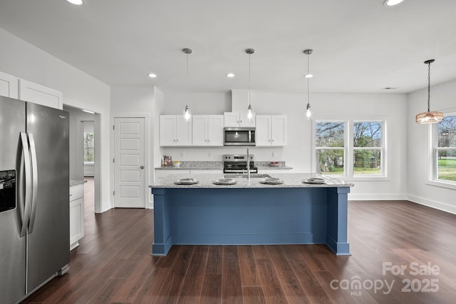 kitchen featuring light stone countertops, recessed lighting, dark wood-style flooring, appliances with stainless steel finishes, and white cabinetry