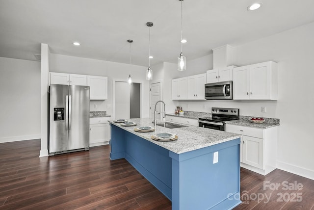 kitchen with dark wood finished floors, white cabinets, stainless steel appliances, and a sink