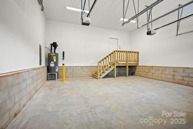 garage with water heater and a garage door opener