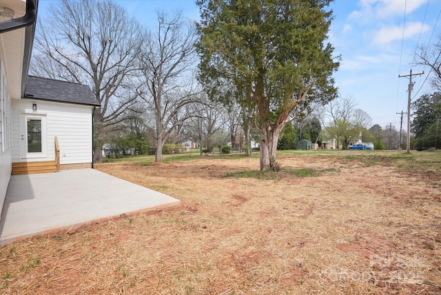 view of yard featuring entry steps and a patio area