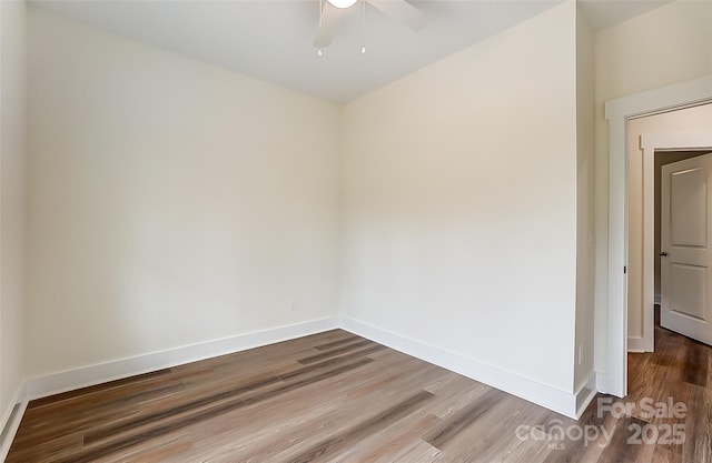 spare room with ceiling fan, baseboards, and wood finished floors