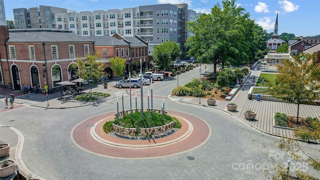 view of street featuring curbs, street lights, and sidewalks