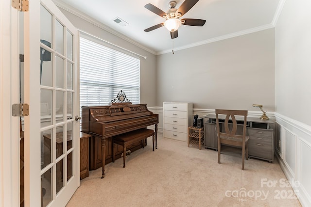 office space featuring ceiling fan, a wainscoted wall, ornamental molding, and carpet flooring