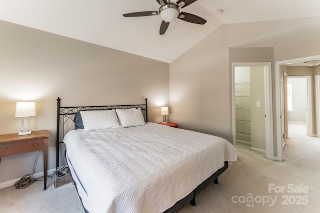 bedroom featuring light carpet, ceiling fan, baseboards, and lofted ceiling