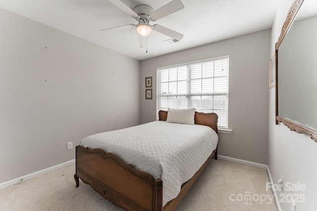 bedroom with visible vents, light colored carpet, baseboards, and ceiling fan