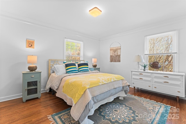 bedroom featuring crown molding, baseboards, and wood finished floors