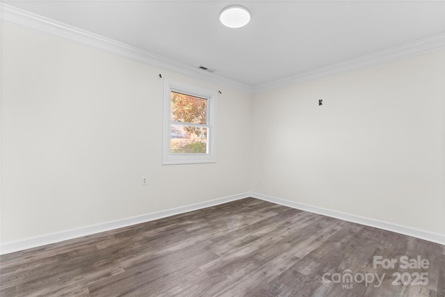 empty room with baseboards, visible vents, ornamental molding, and dark wood-style flooring