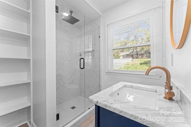 bathroom featuring vanity and a shower stall