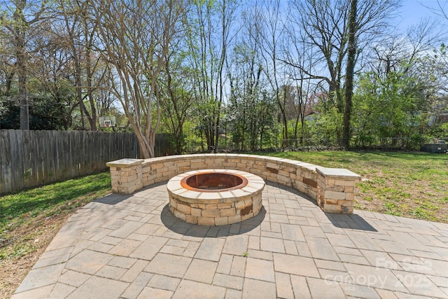 view of patio with an outdoor fire pit and a fenced backyard
