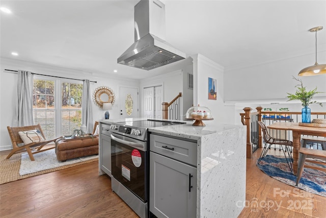 kitchen featuring gray cabinets, light stone countertops, light wood-type flooring, electric stove, and extractor fan