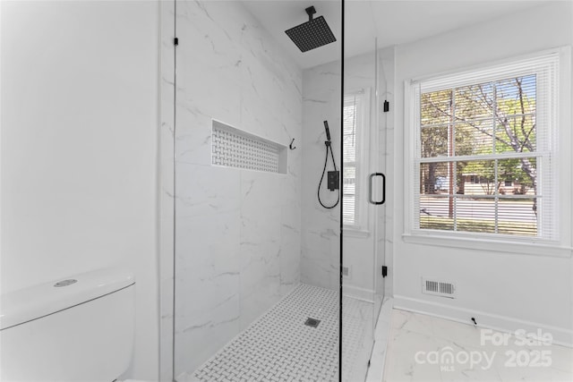 full bathroom featuring toilet, a marble finish shower, marble finish floor, baseboards, and visible vents