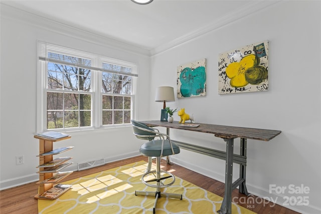 office featuring wood finished floors, ornamental molding, baseboards, and visible vents