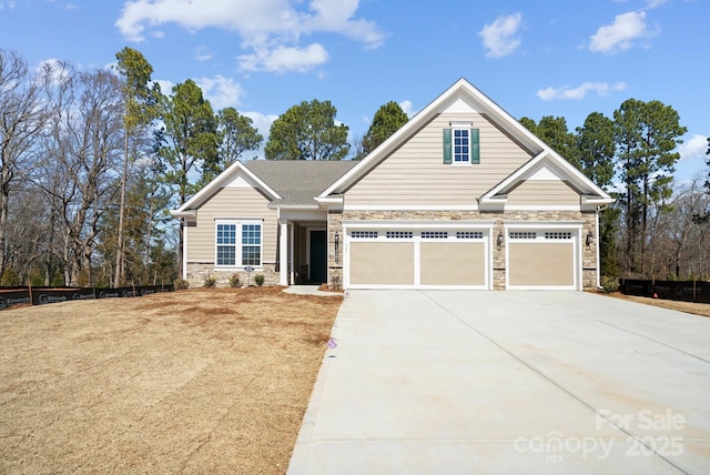 craftsman inspired home with stone siding, an attached garage, and driveway