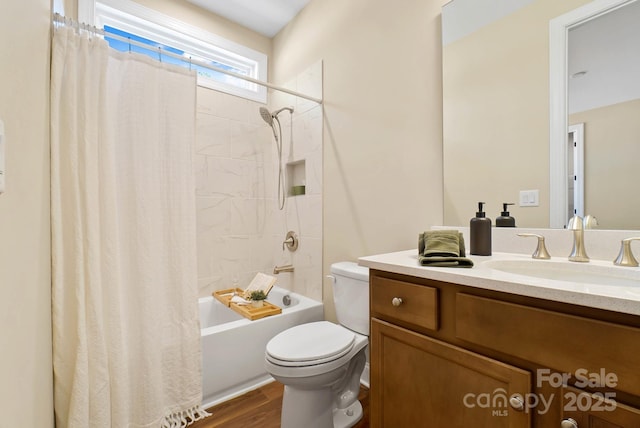 full bath with shower / tub combo with curtain, toilet, vanity, and wood finished floors