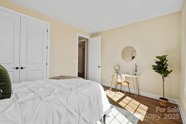 bedroom with wood finished floors and baseboards