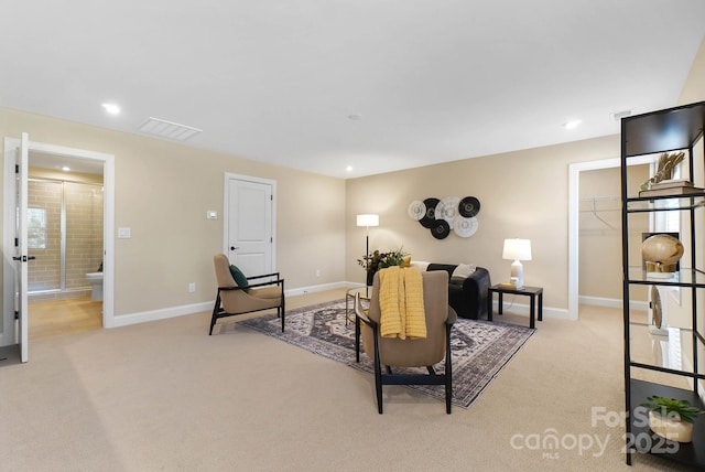 living area with light carpet, visible vents, recessed lighting, and baseboards