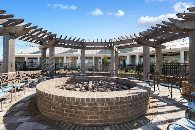 view of patio / terrace featuring a pergola, an outdoor fire pit, and fence