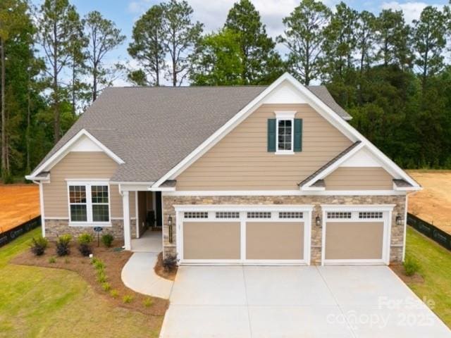 13101 Cozy Ct, Charlotte, NC 28215 - craftsman-style house featuring stone siding, driveway, a front yard, and an attached garage