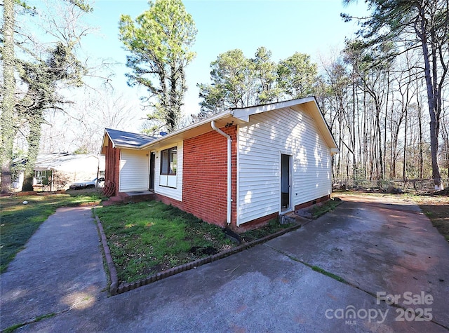 view of side of home featuring brick siding