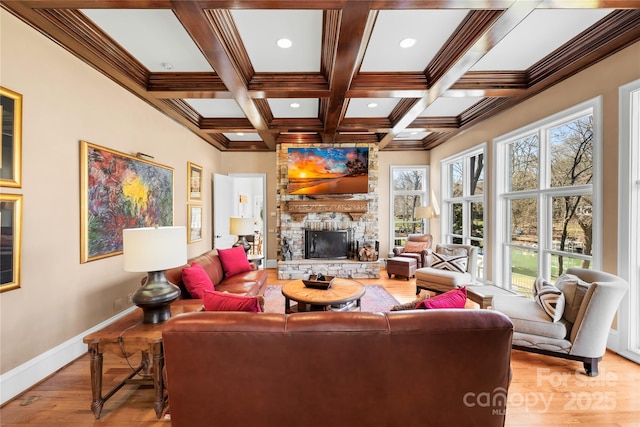 living area with baseboards, beam ceiling, coffered ceiling, and a fireplace