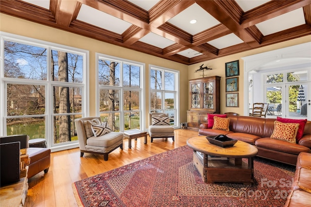 sunroom with arched walkways, beam ceiling, and coffered ceiling