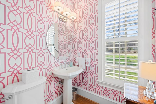 bathroom featuring wallpapered walls and toilet