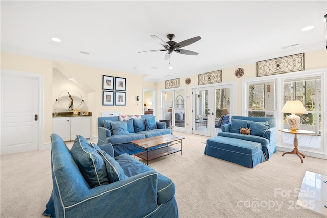 living area featuring recessed lighting, french doors, light colored carpet, and visible vents