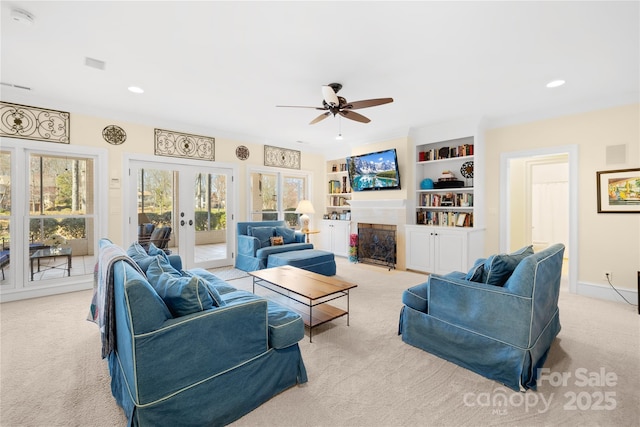 living area with a fireplace with flush hearth, french doors, recessed lighting, and carpet floors