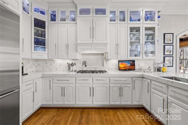 kitchen featuring light stone counters, stainless steel appliances, and white cabinetry