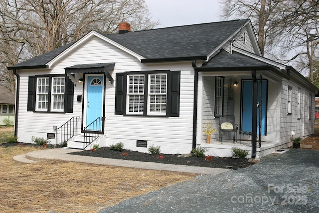 bungalow featuring crawl space, roof with shingles, a chimney, and entry steps