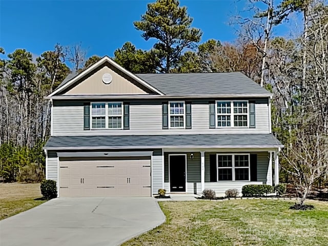 traditional-style home with a porch, a front lawn, an attached garage, and driveway