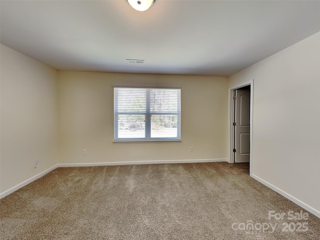 carpeted empty room with baseboards and visible vents