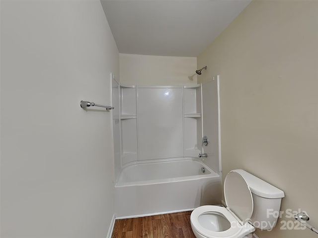 bathroom with toilet, shower / bath combination, and wood finished floors