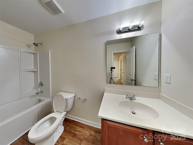 bathroom featuring visible vents, toilet, shower / tub combination, baseboards, and vanity