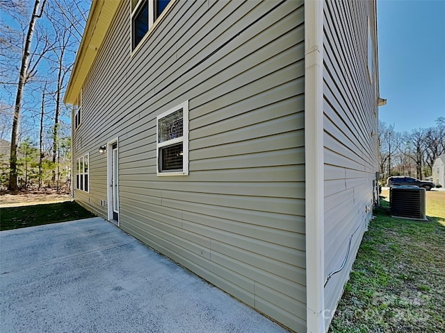 view of property exterior featuring central AC unit and a patio area