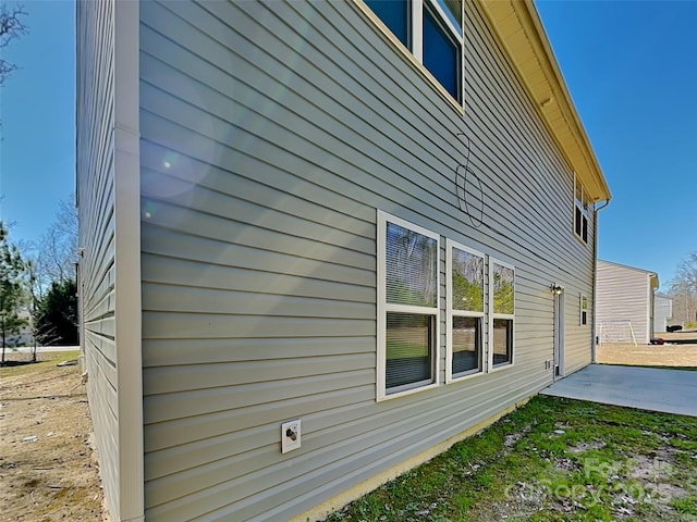 view of side of home with a patio area